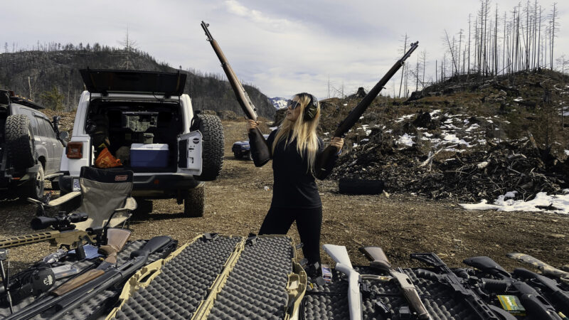 girl holding two m1 garand